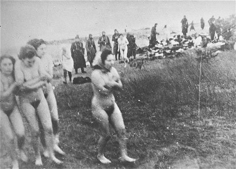 A group of naked Jewish women and girls walk to the execution site on the beach near Liepaja
